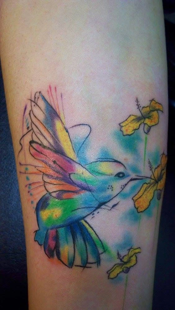 Colorful hummingbird and floral tattoo artwork